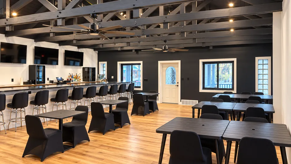 The Main Bar: dining tables under the timber trusses