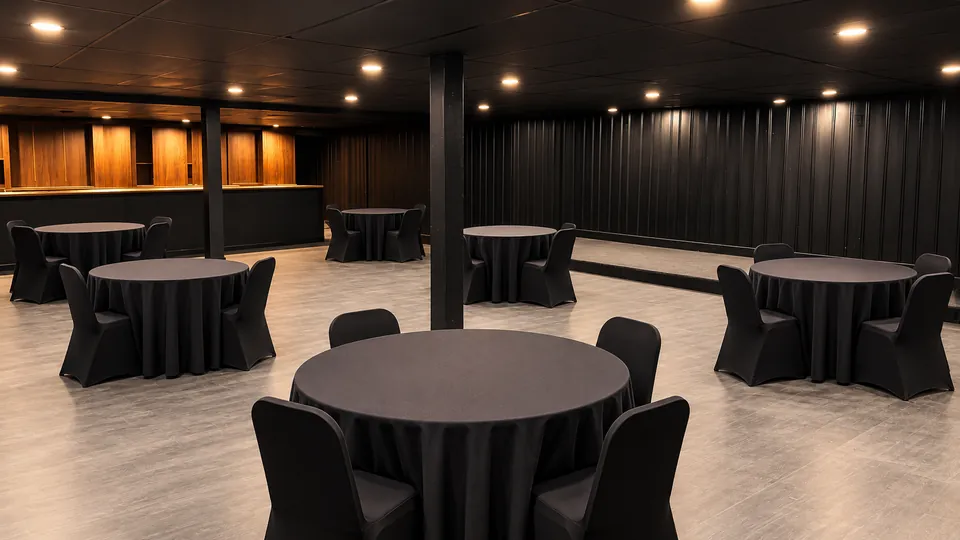 The Underground: round tables in front of the lit walnut back bar